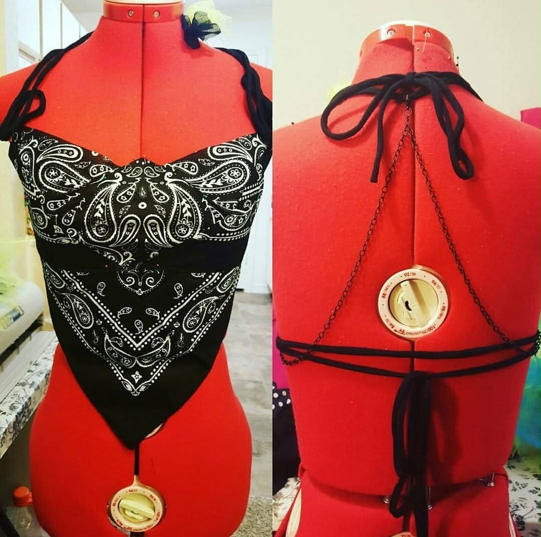 Front and back views of a black bandana halter top with long ties and clock pendant