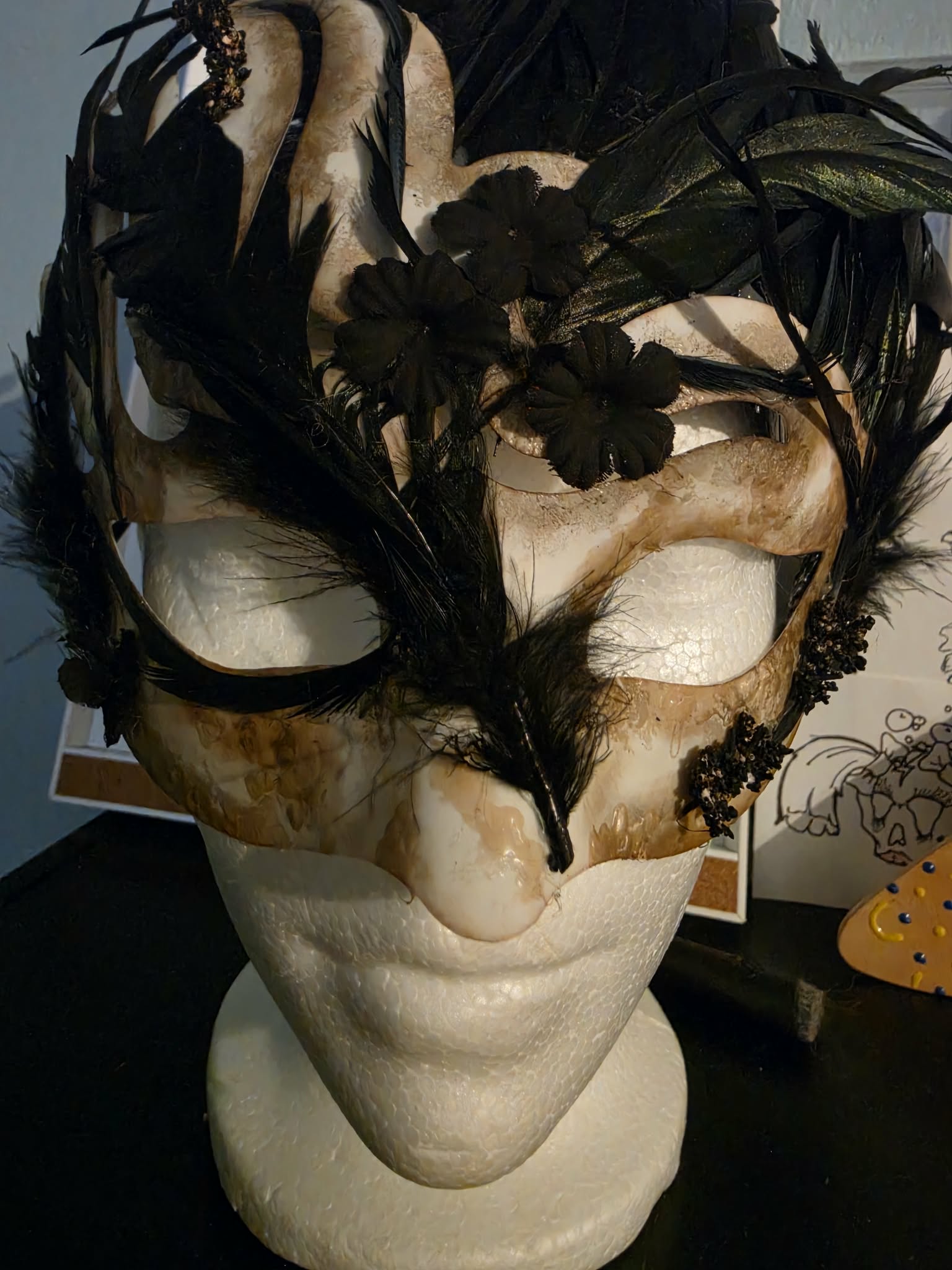 Handmade black feather masquerade mask shown from the front