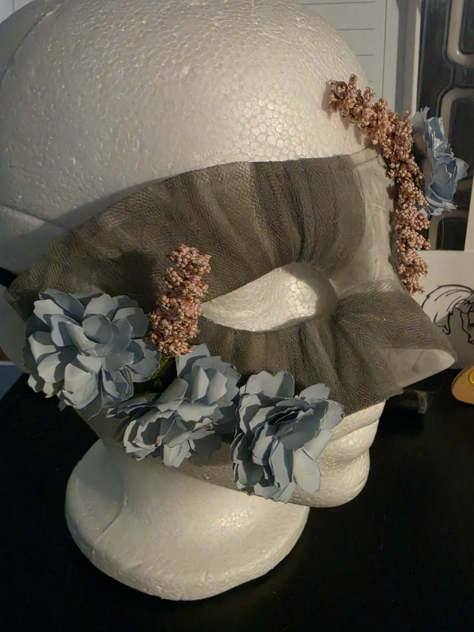 Gray veil mask trimmed with blue and bronze flowers