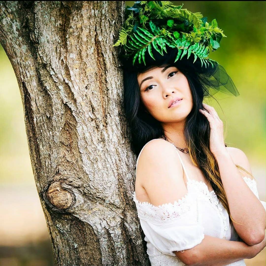 Outdoor portrait wearing a vivid green botanical headpiece