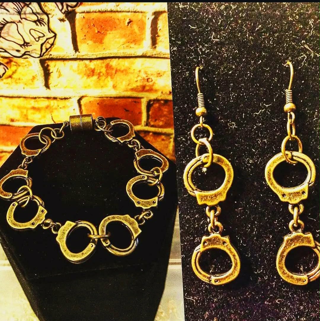 Handmade bracelet and drop earrings formed from circular handcuff-style links