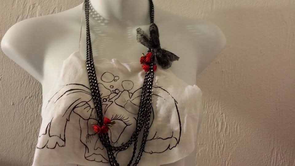 Punk Bubble logo crop top styled with layered black necklaces and red flower details