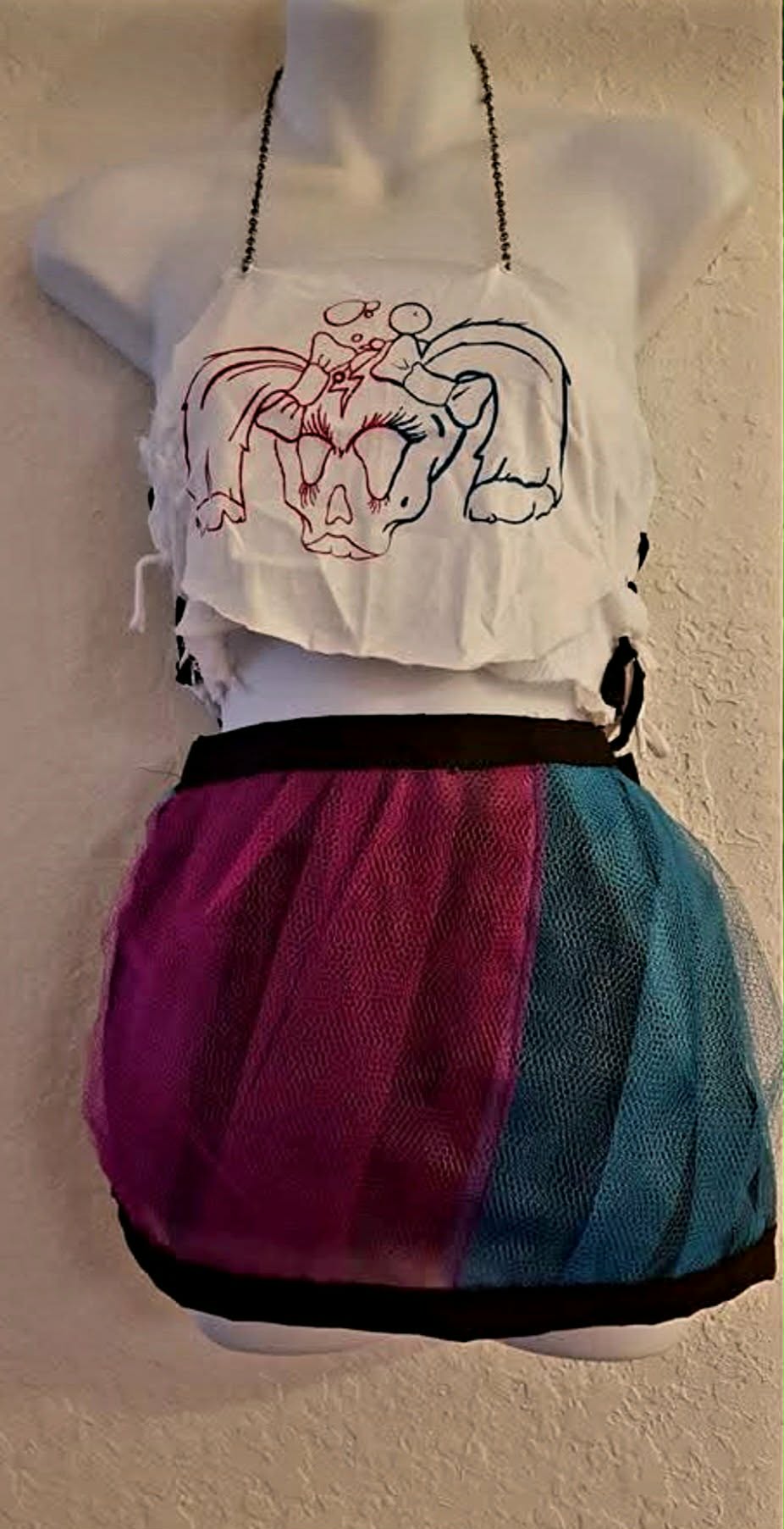 A handmade Punk Bubble outfit featuring the crowned skull logo and a pink, purple, and blue tulle skirt